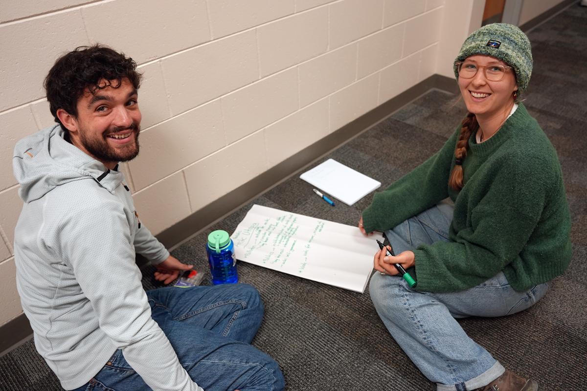 To personer smiler til kamera.